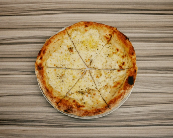 A pizza sitting on top of a wooden table